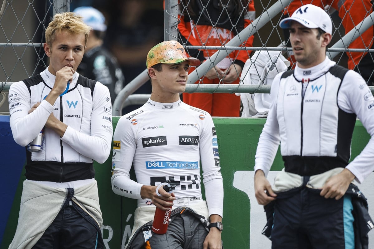 Albon, Norris and Latifi standing together looking relaxed at the 2022 Mexico GP