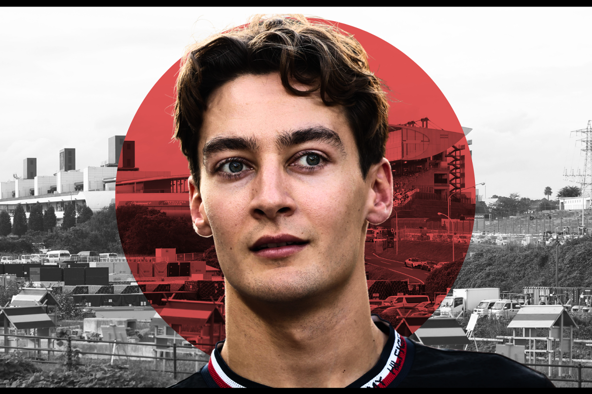 George Russell looks on with the Japan flag in the background