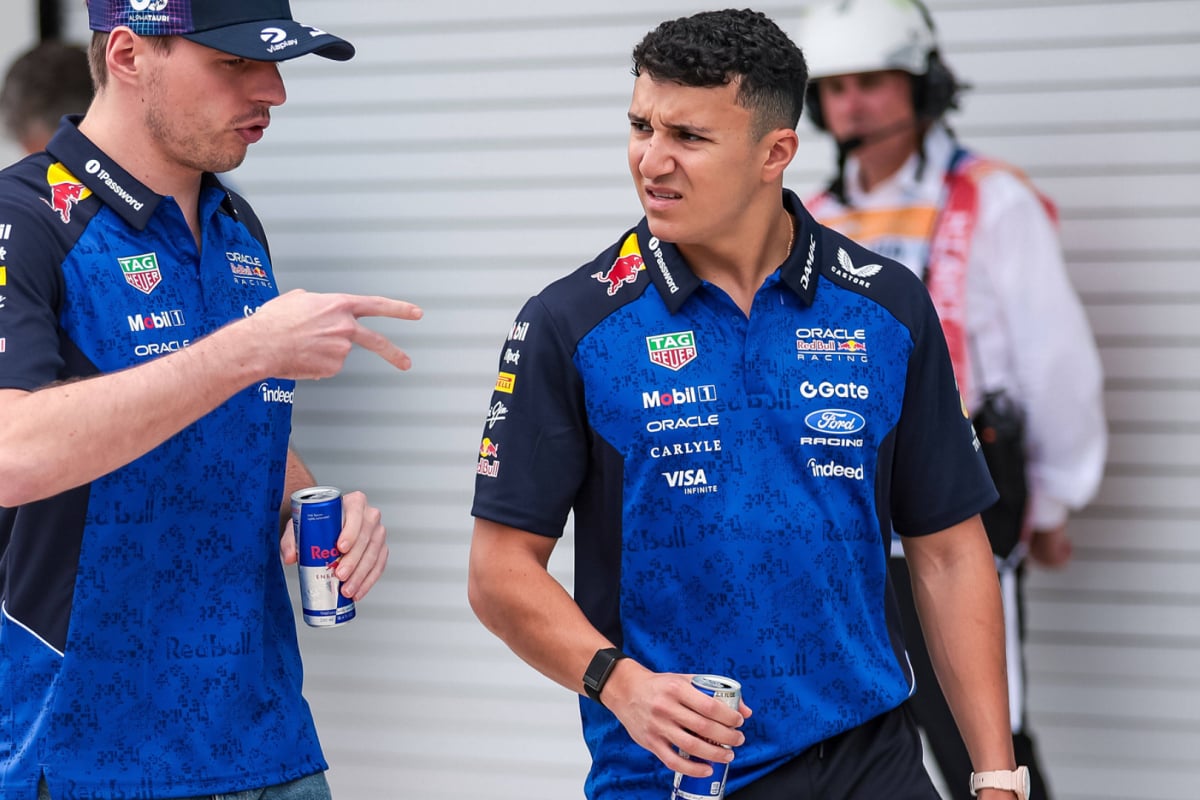 An image of Red Bull F1 drivers Isack Hadjar and Max Verstappen in conversation