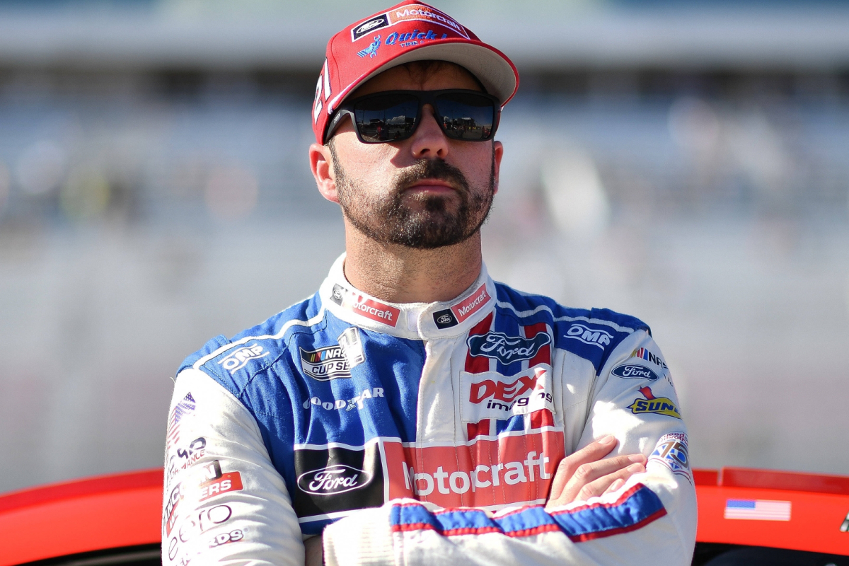 An image of NASCAR driver Josh Berry at a race weekend with his arms crossed