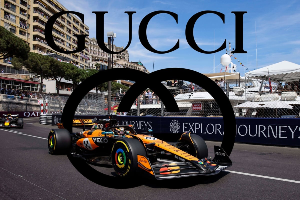 Lando Norris drives at the Monaco GP with the Gucci logo in the background