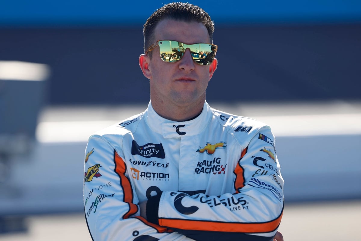 An image of NASCAR driver AJ Allmendinger staring down the camera with his arms crossed