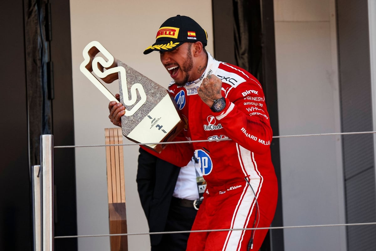 Lewis Hamilton celebrates on the podium at the Barcelona GP