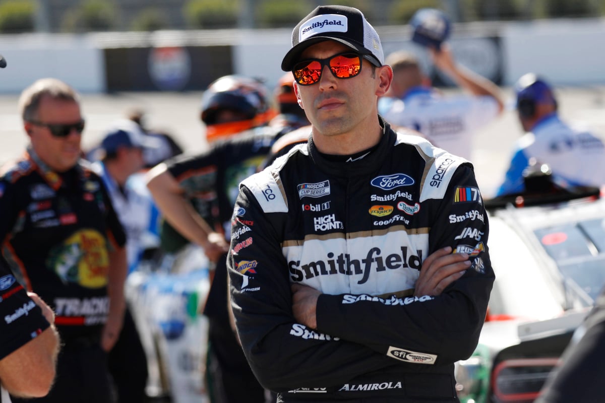 An image of NASCAR driver Aric Almirola with his arms crossed
