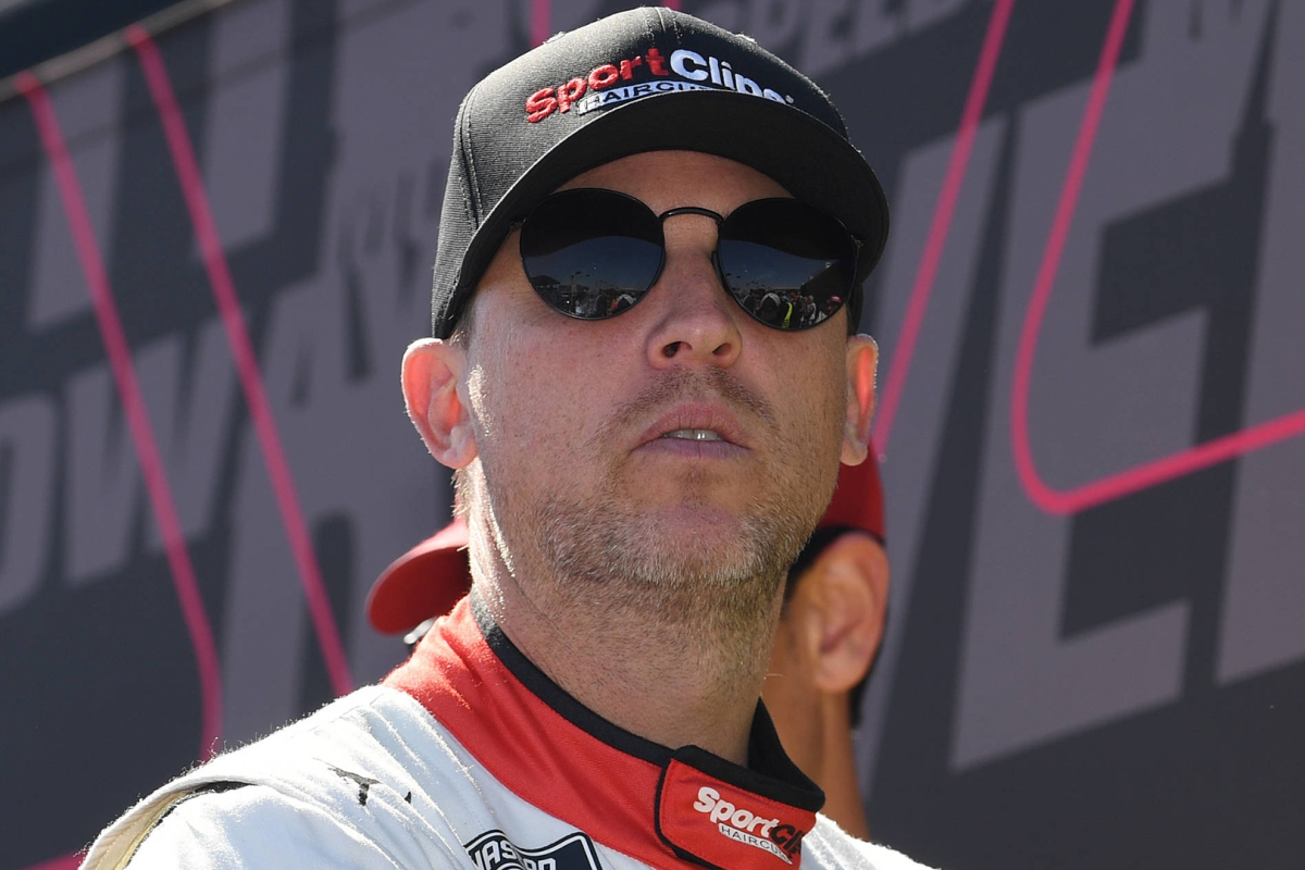An image of Joe Gibbs Racing driver and 23XI owner Denny Hamlin looking serious