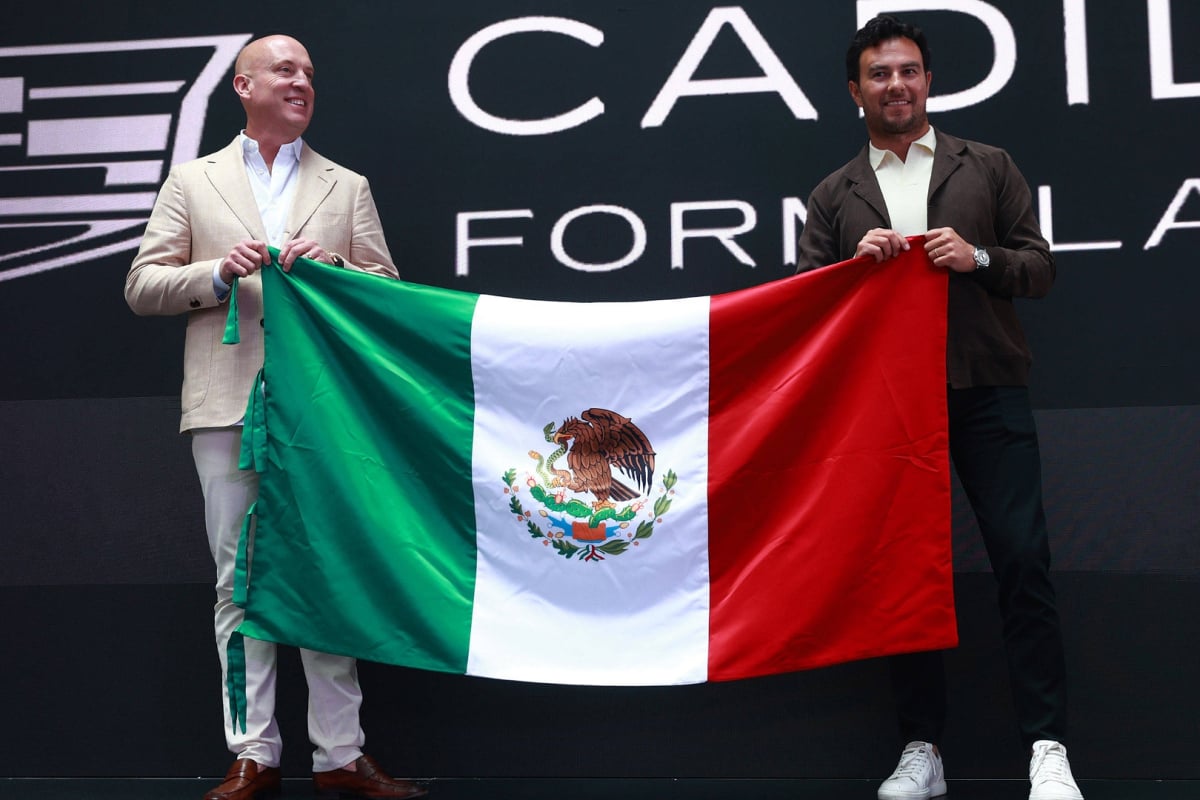 Cadillac F1 CEO Dan Towriss holding Mexican flag with Sergio Perez