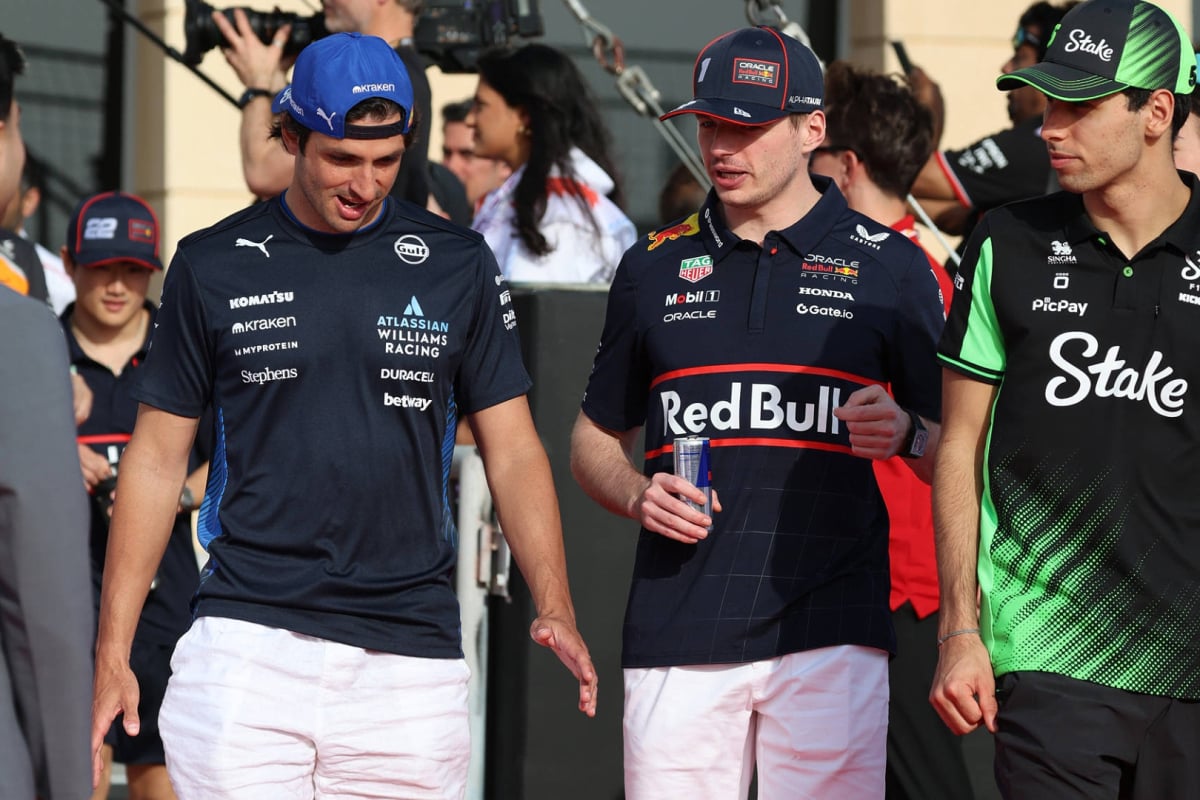 Sainz, Verstappen and Bortoleto walking together in the F1 paddock