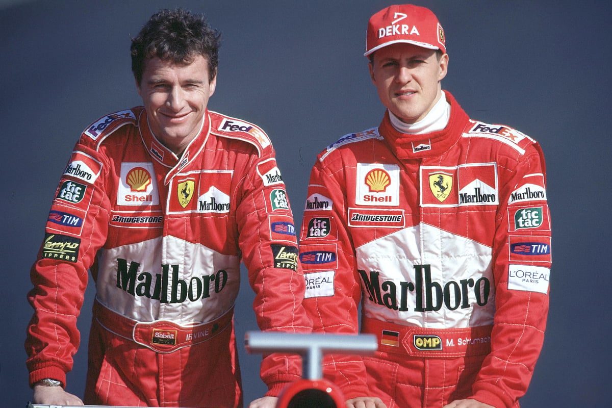 Michael Schumacher and Eddie Irvine stand behind the rear wing at the launch of the 1999 F1 car