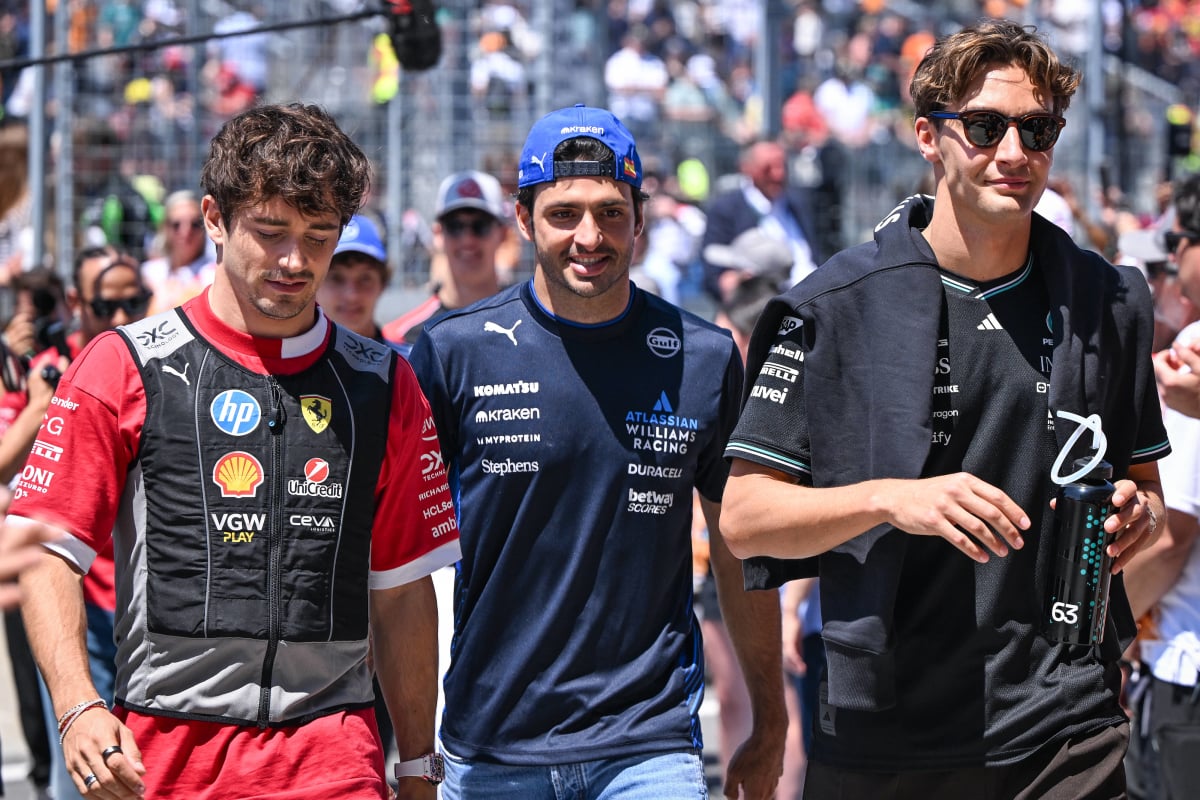 Charles Leclerc walks alongside Carlos Sainz and George Russell