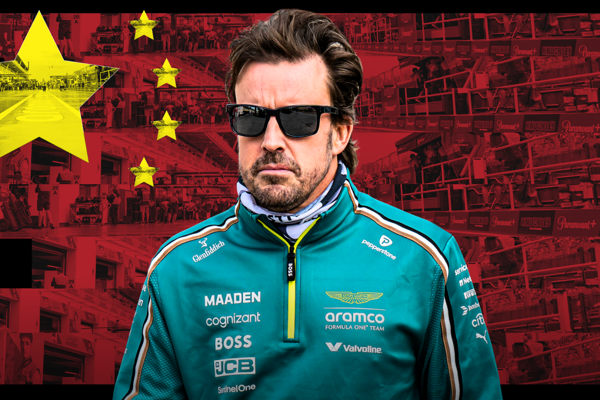 Fernando Alonso in Aston Martin teamwear pictured in front of a Chinese flag