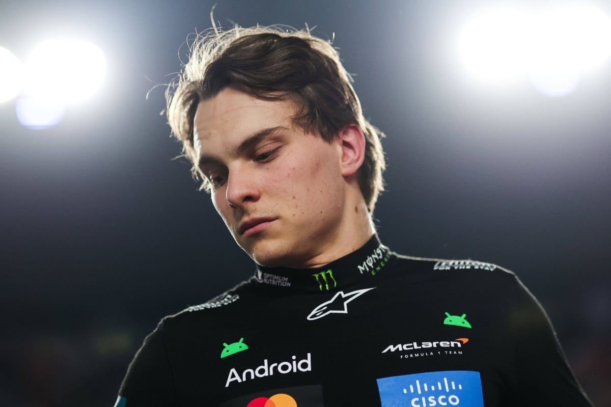 Zoomed in picture looking up at Piastri in black McLaren F1 kit