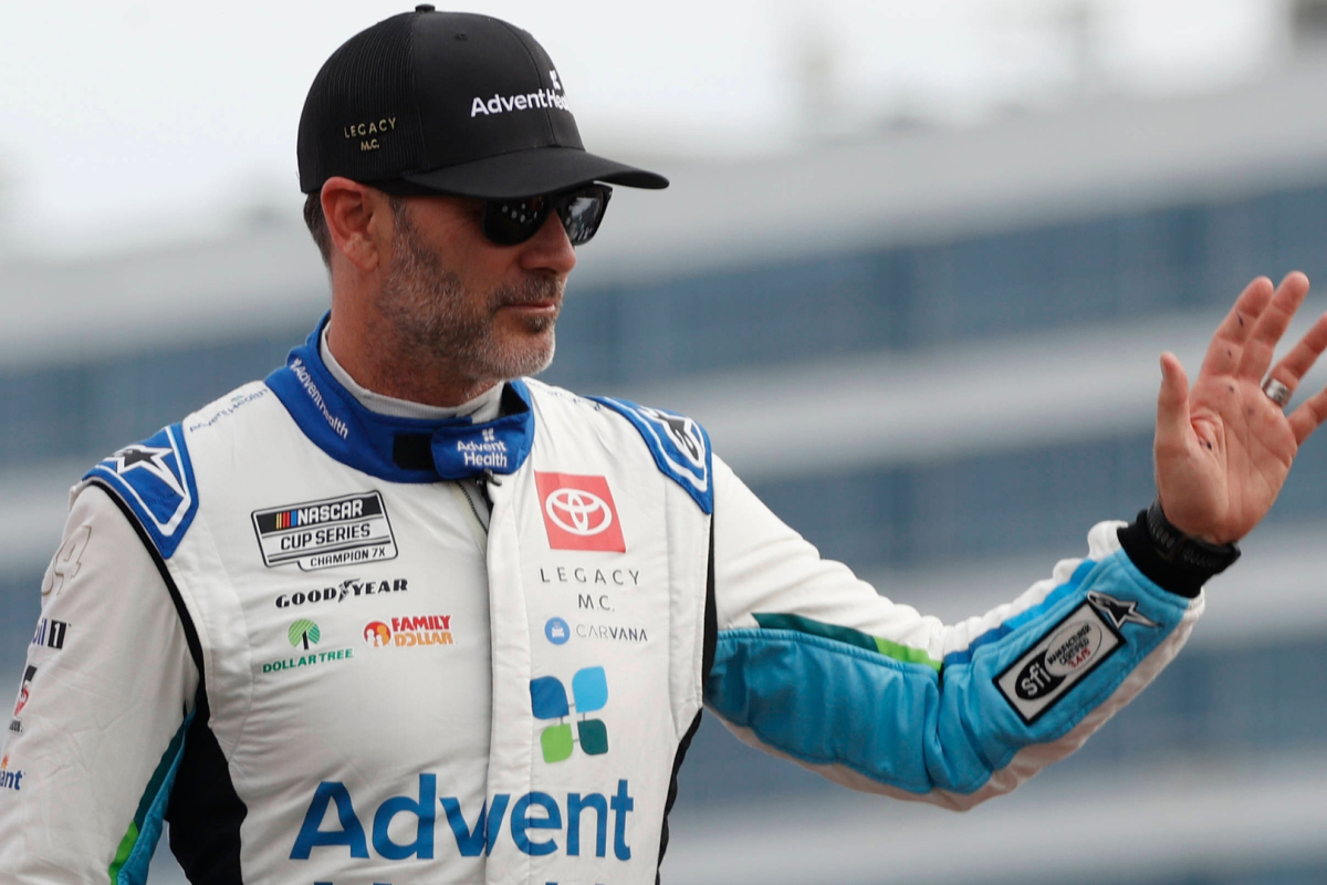 An image of NASCAR legend Jimmie Johnson waving to a crowd of fans