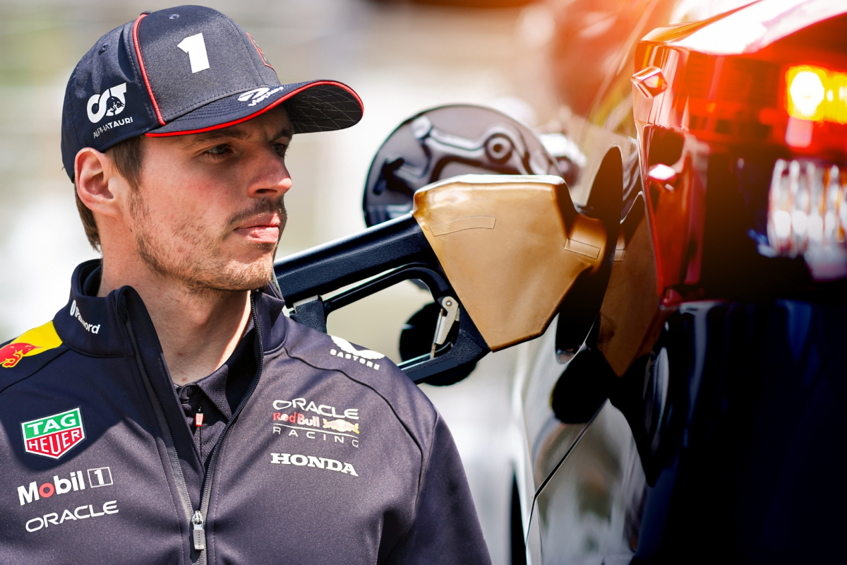 Max Verstappen looks on with a background of a car being filled with petrol