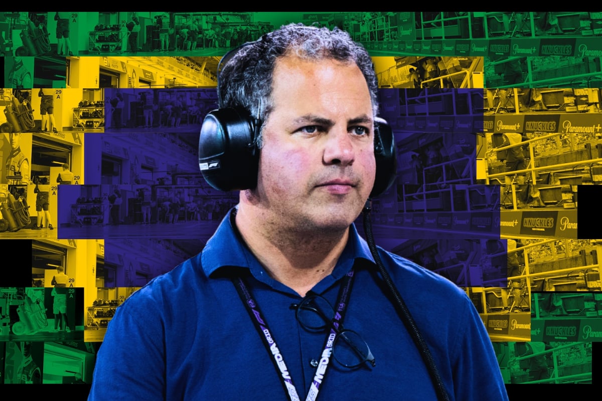 Kravitz looking serious with his F1 media lanyard and ear defenders on in front of a Brazilian-paddock themed background