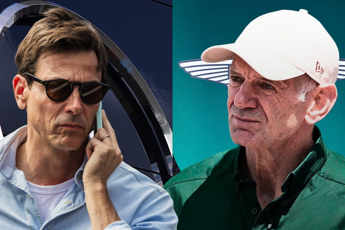 Toto Wolff and Adrian Newey look at one another in front of Mercedes and Aston Martin logos