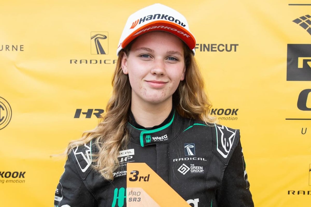 Rachel Robertson stands with a trophy after finishing third