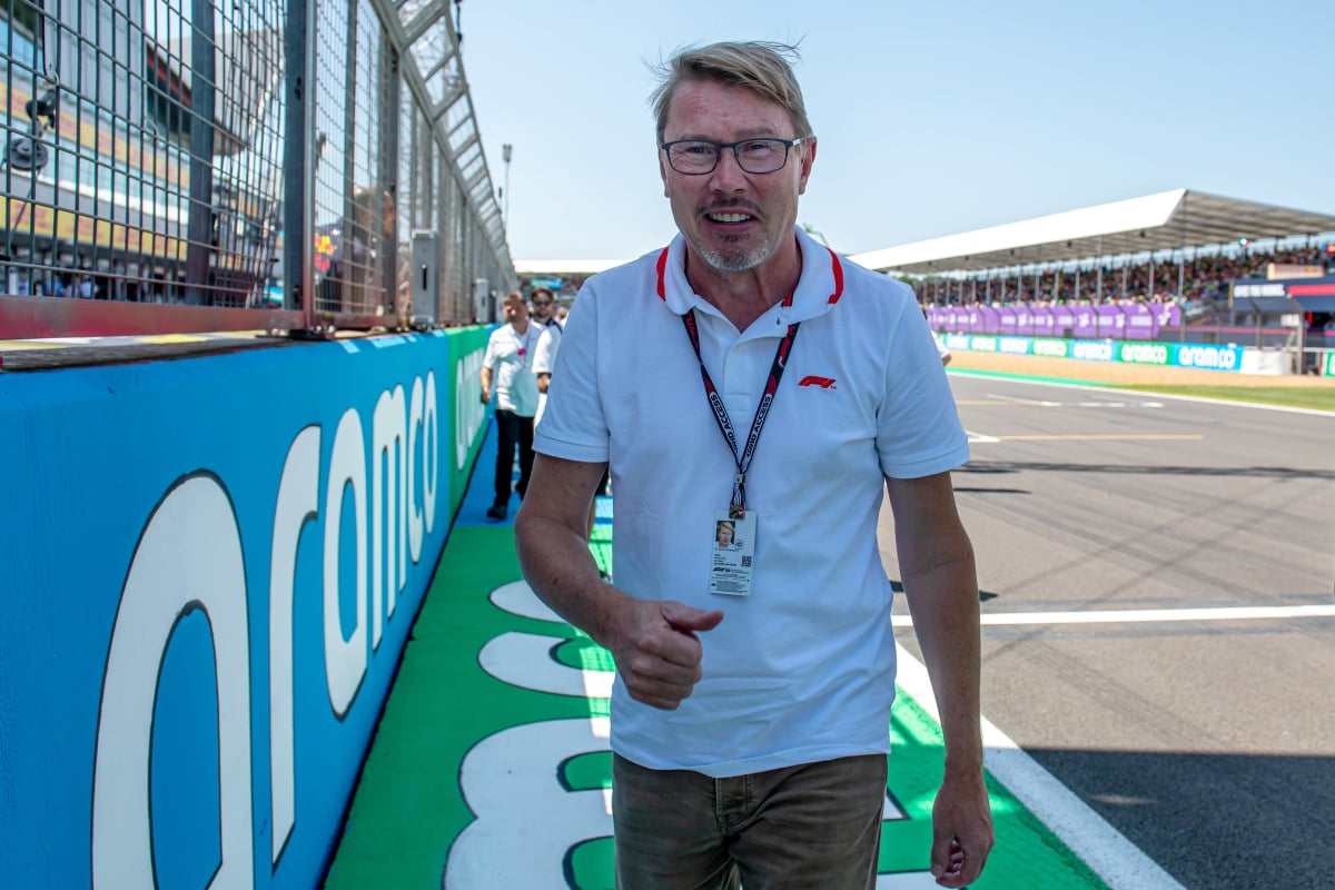 Mika Hakkinen walks around the paddock at the British Grand Prix