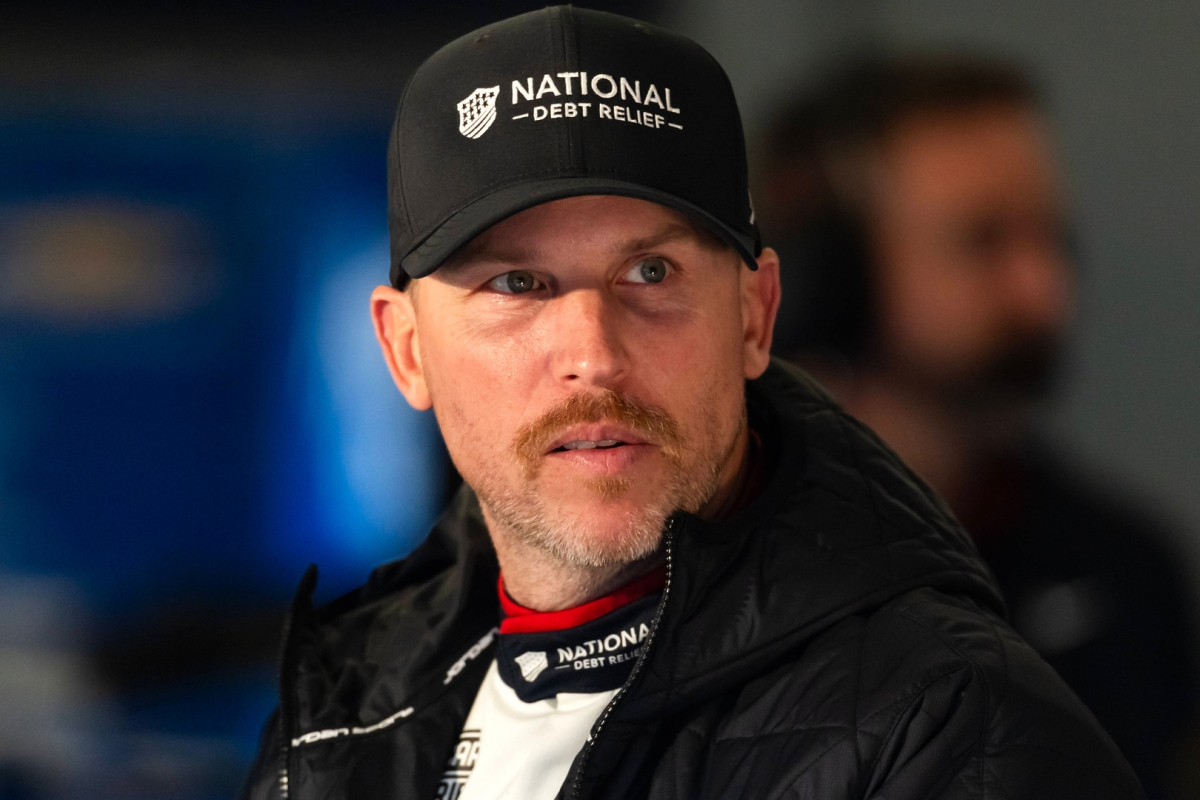 An image of Joe Gibbs Racing driver and 23XI owner Denny Hamlin looking startled