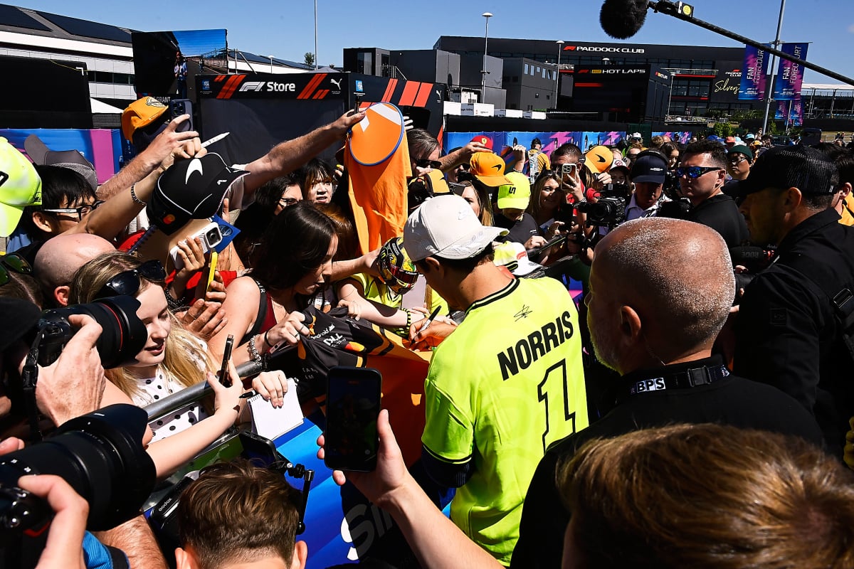 Lando Norris signs autographs for fans at Silverstone