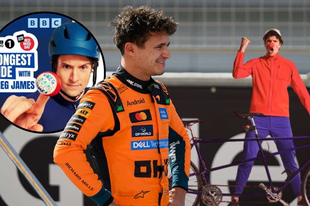 Lando Norris smiles and looks across at Greg James cheering as he holds his tandem
