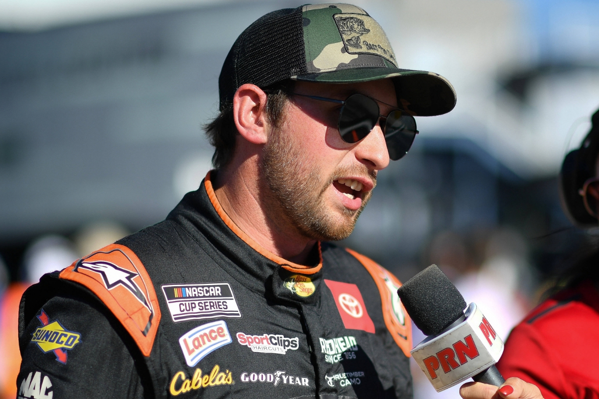 An image of Joe Gibbs Racing NASCAR driver Chase Briscoe speaking to a pit road reporter