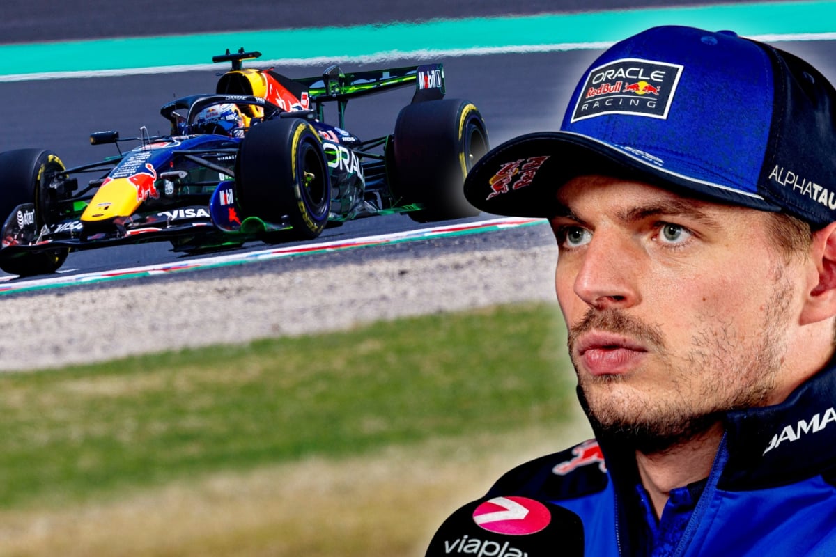 Headshot of Verstappen holding a Viaplay mic looking annoyed with the background of his RB22 on track