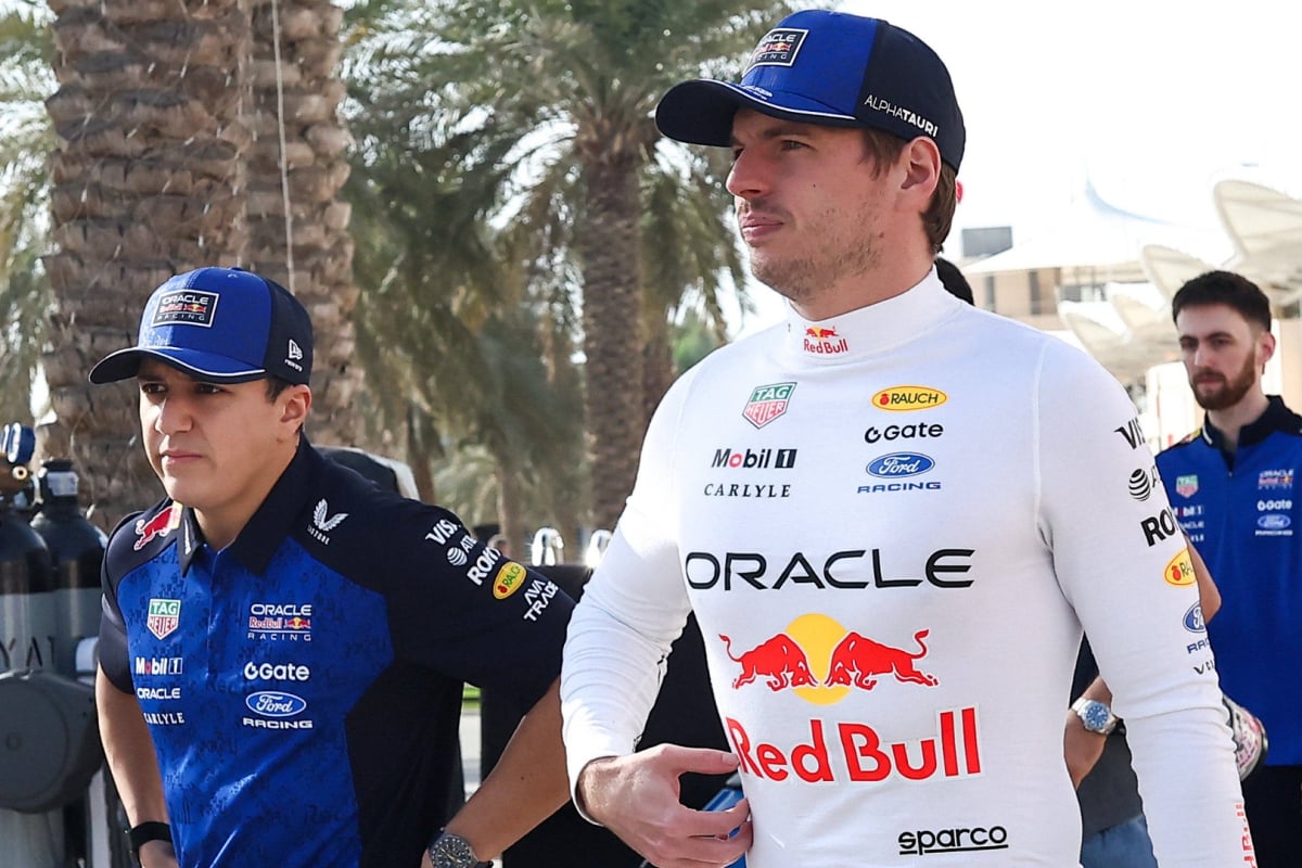 Max Verstappen and Isack Hadjar walking into the Bahrain paddock during pre season testing