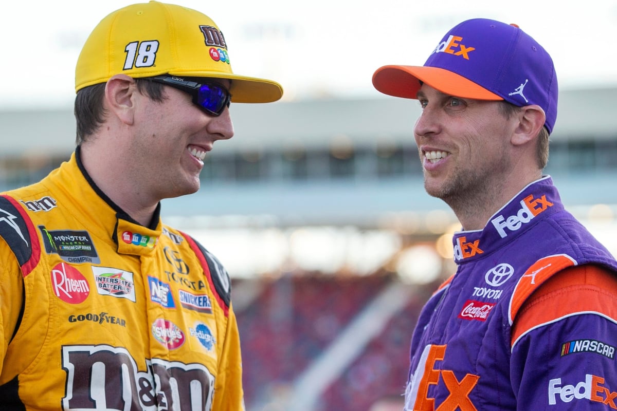 An image of NASCAR stars Denny Hamlin and Kyle Busch smiling in 2018