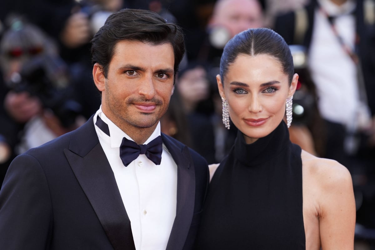 Carlos Sainz and Rebecca Donaldson look at the camera in black tie at the Cannes film festival