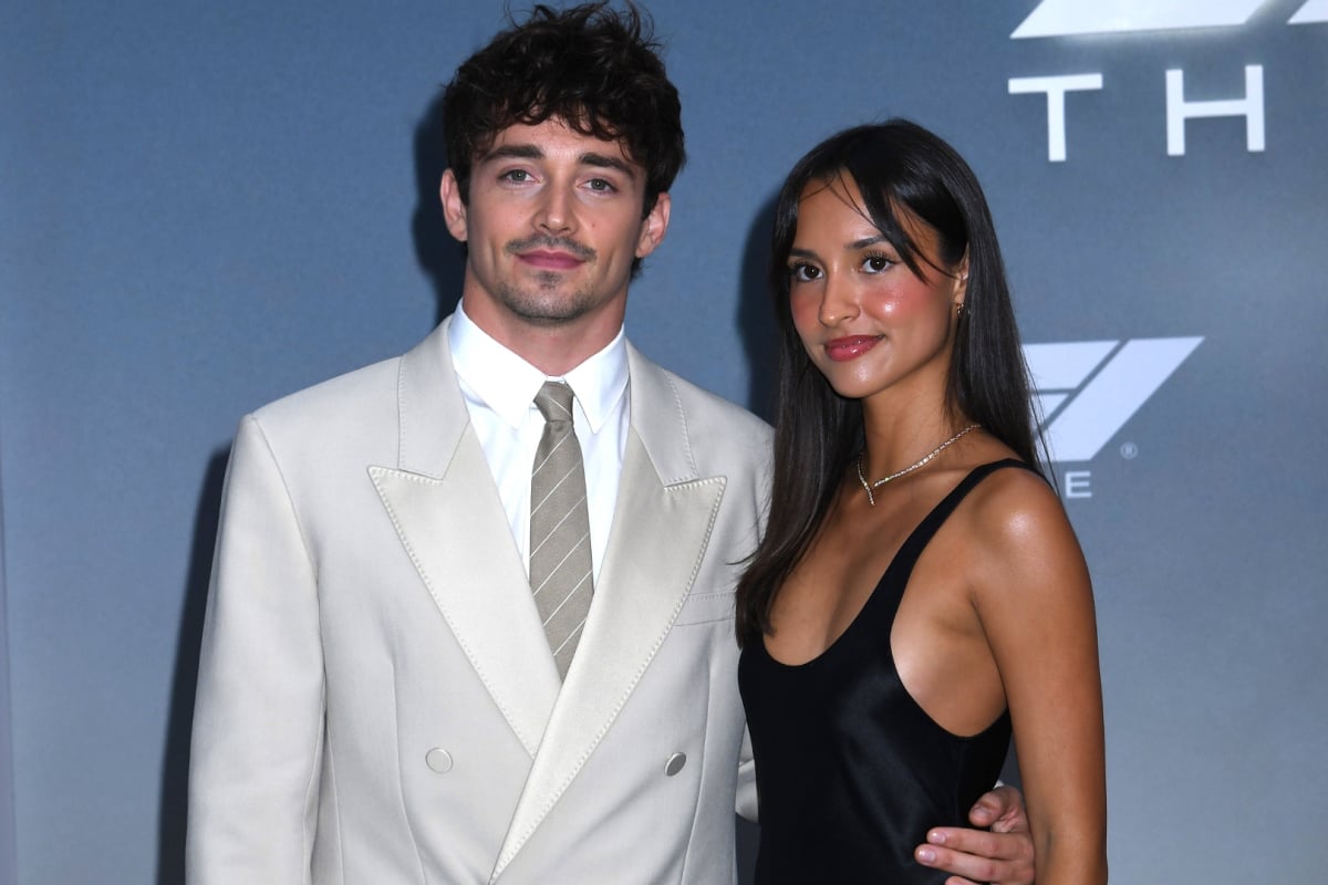 Charles Leclerc and partner Alexandra Saint Mleux posing on F1 Movie premiere carpet in a suit and a dress