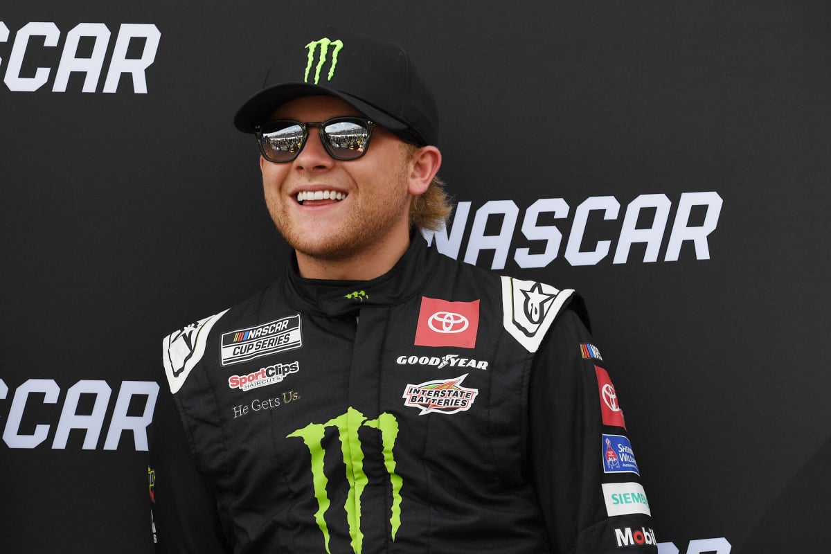 An image of NASCAR driver Ty Gibbs with a huge smile on his face
