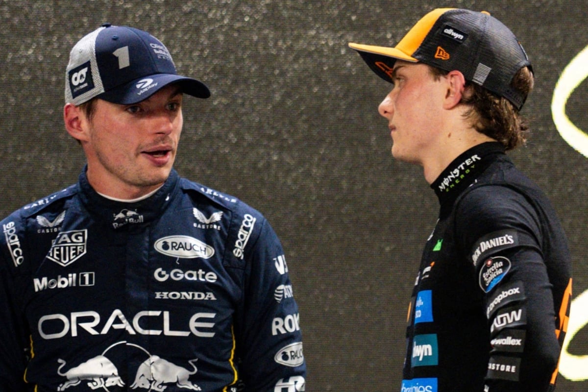 Piastri watching Verstappen talk after the Singapore GP 