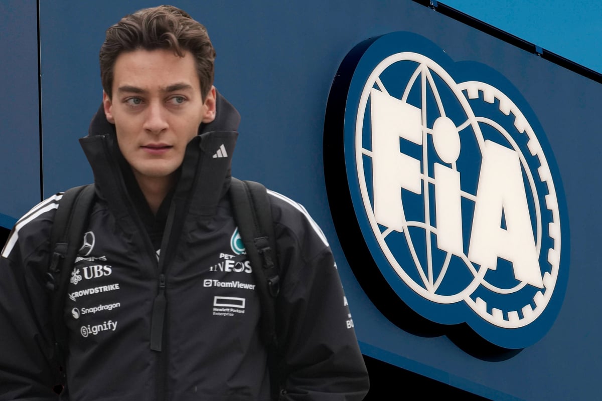 George Russell looks at the FIA logo