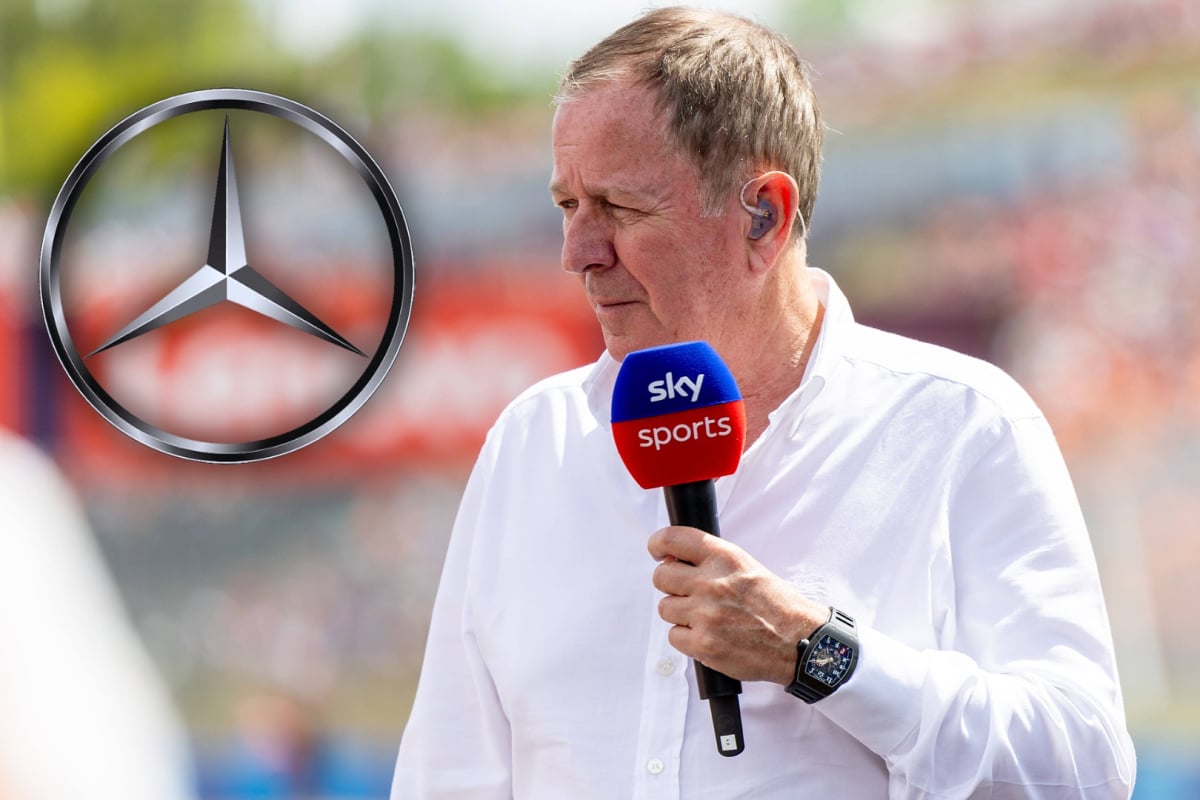Brundle holding Sky Sports F1 microphone with silver and black Mercedes logo edited to his left