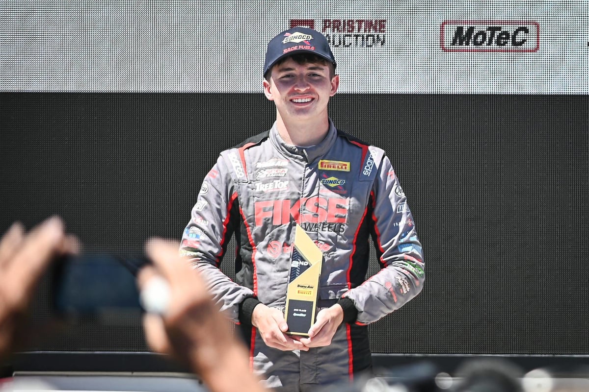 Brent Crews holds a trophy after a 2024 win at Road America