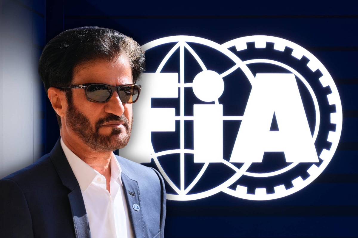 mohammed ben sulayem looking serious with sunglasses on in front of dark blue background and white FIA logo