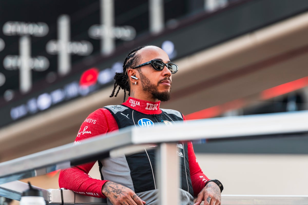 Lewis Hamilton in his Ferrari race suit with sunglasses on ahead of the Abu Dhabi Grand Prix in 2025