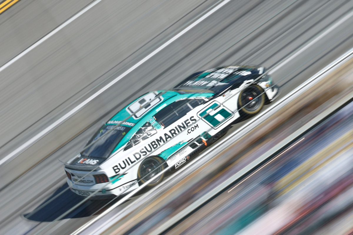 An image of NASCAR star Brad Keselowski driving at full speed at Talladega Superspeedway