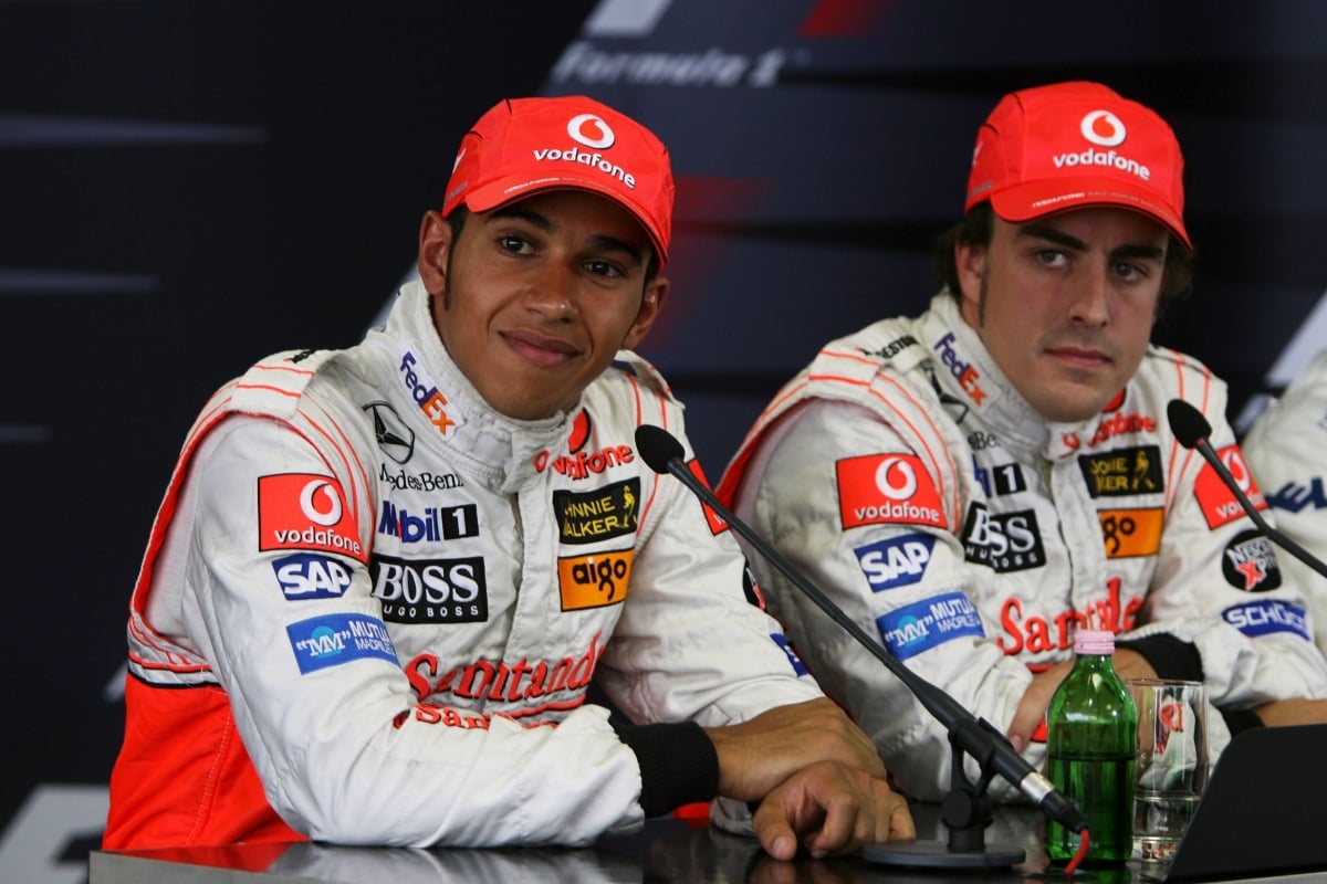 McLaren's Lewis Hamilton and Fernando Alonso look on from a 2007 Hungarian Grand Prix press conference 