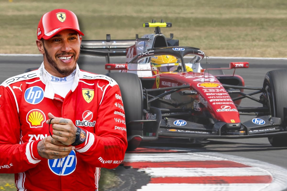 Lewis Hamilton smiles with a background of his Ferrari car