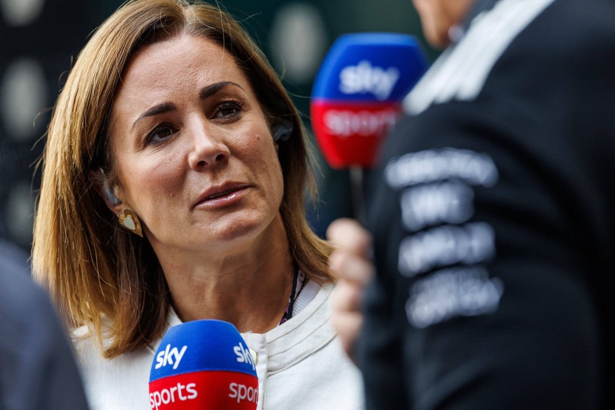 Natalie Pinkham looking serious in a closeup shot holding a Sky Sports microphone