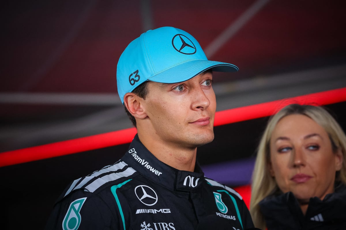 An image of Mercedes F1 driver George Russell talking to the media