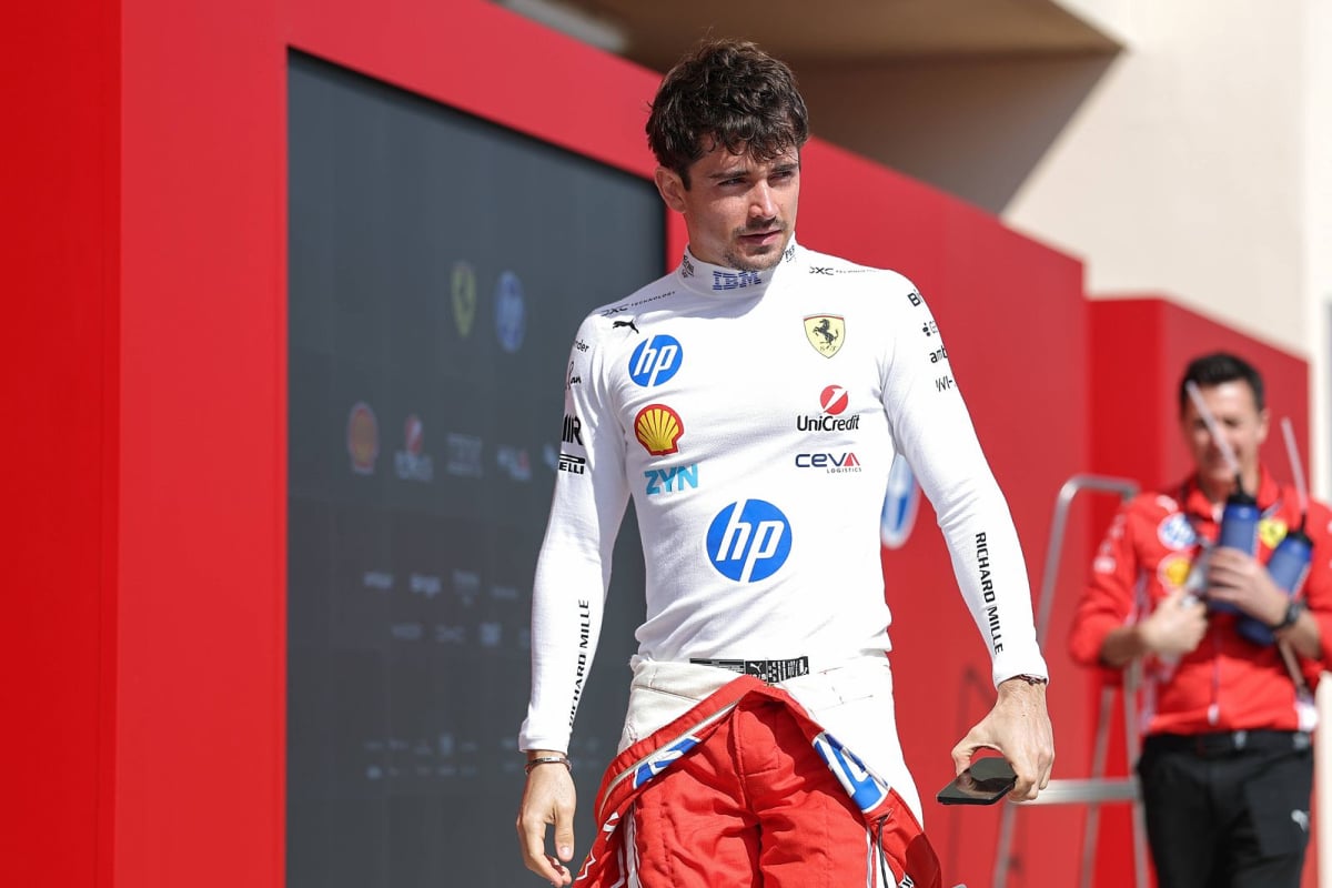 Charles Leclerc looks on in the paddock at the Sakhir Circuit
