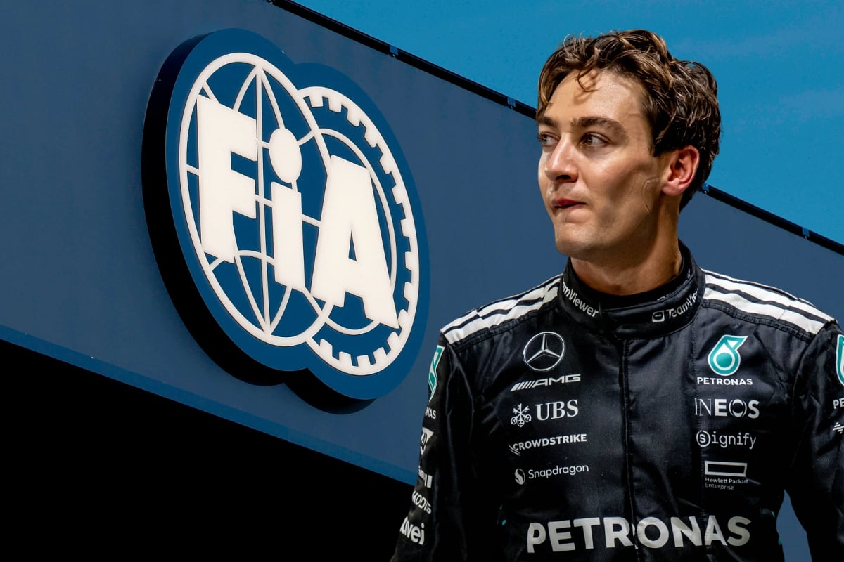 George Russell looks at the FIA logo