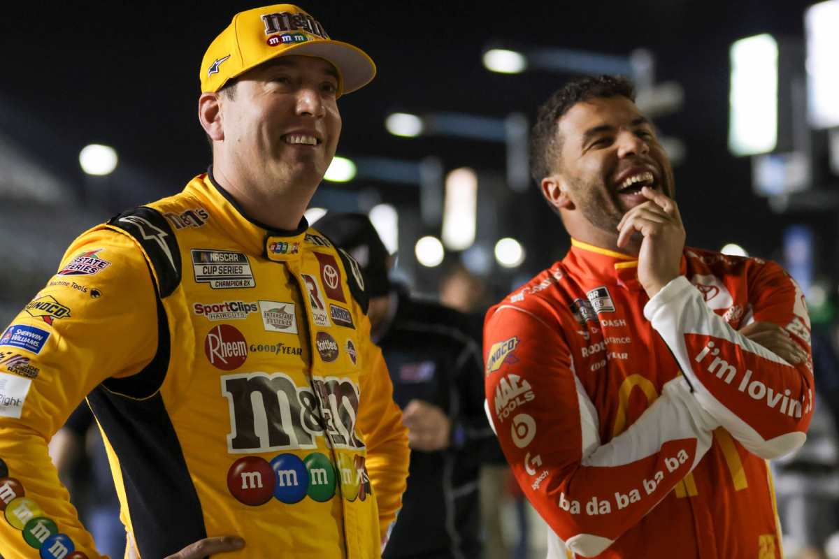 An image of NASCAR drivers Kyle Busch and Bubba Wallace laughing together on pit road