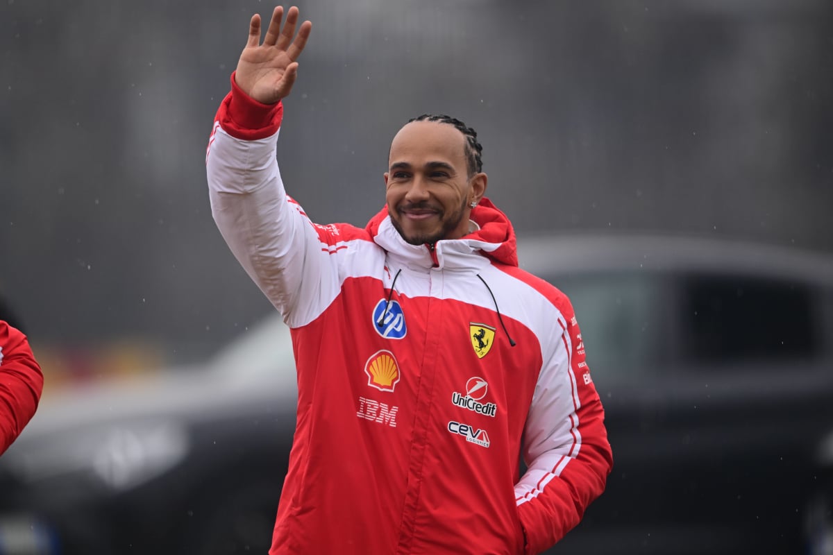 Lewis Hamilton waves to the crowd at Ferrari's shakedown