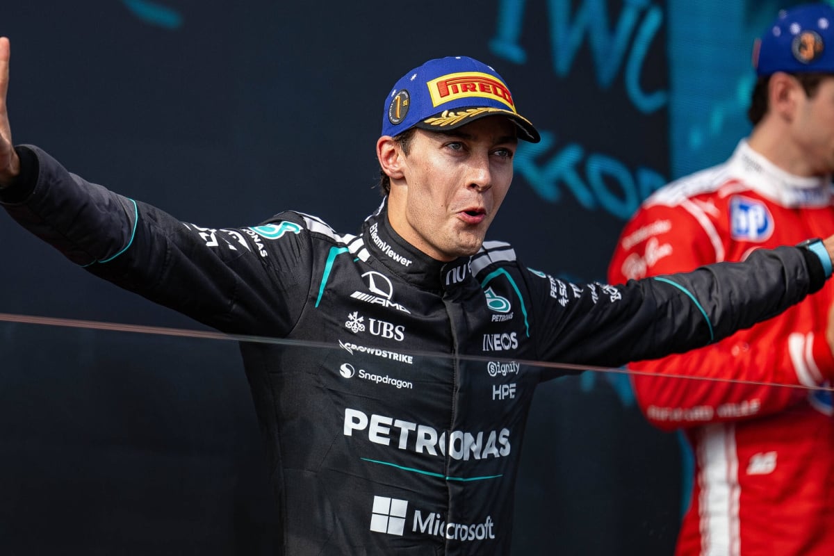 George Russell doing his signature pose on the podium at the 2026 Australian Grand Prix
