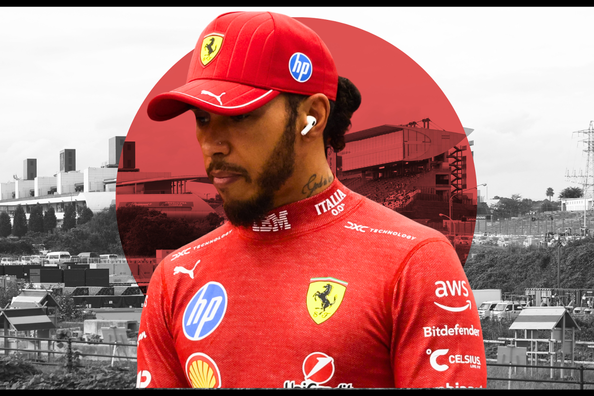Lewis Hamilton looks on with the Japan flag in the background