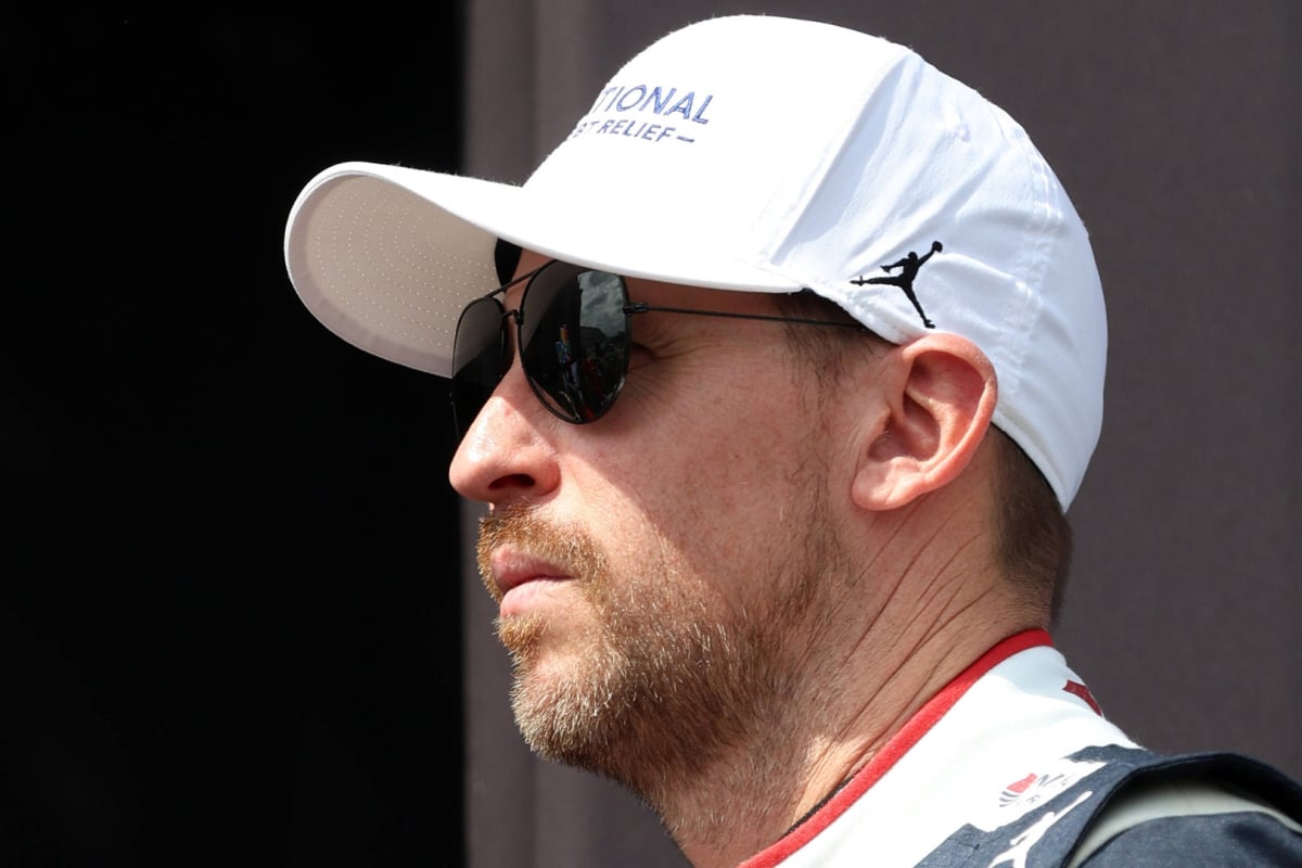 An image of Joe Gibbs Racing driver and 23XI owner Denny Hamlin from the side