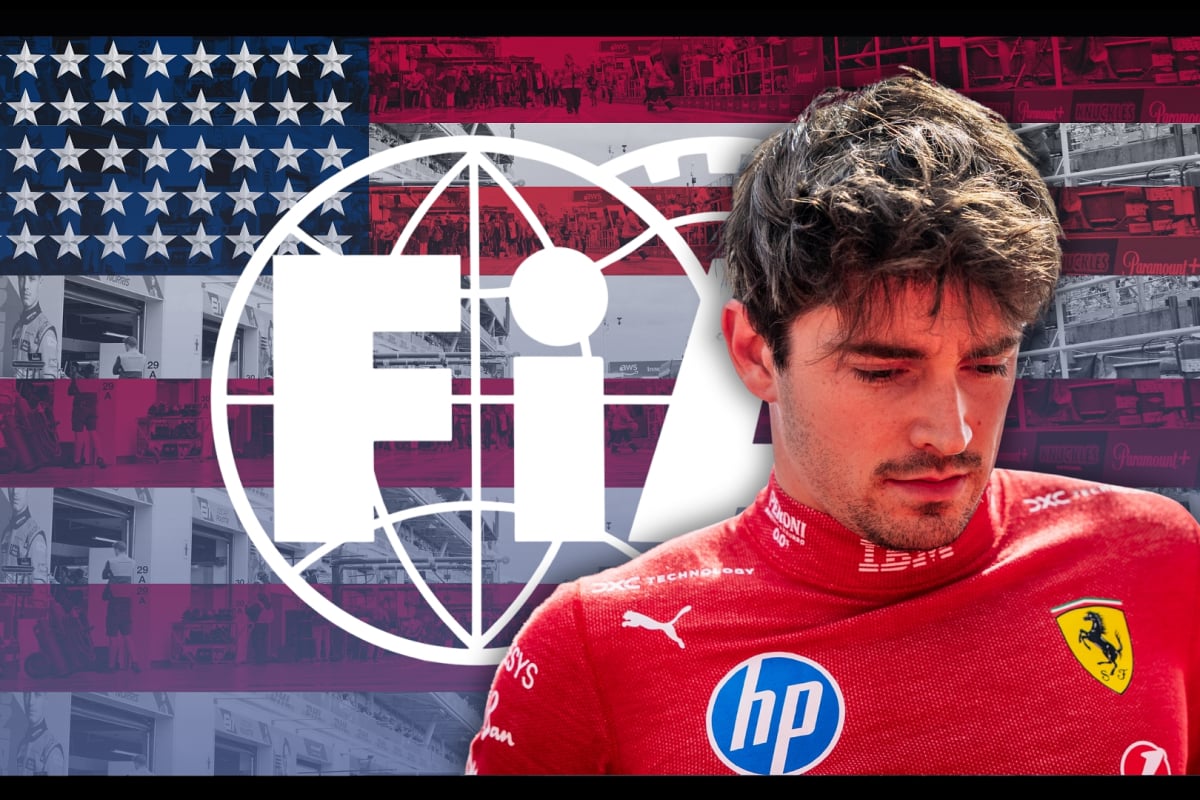 Leclerc in Ferrari race suit looking down with a glum expression in front of a US flag-themed FIA logo